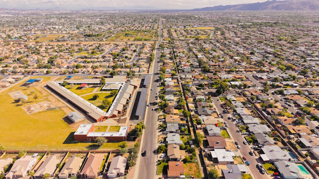Aerial view of a suburban neighborhood with a long road.
